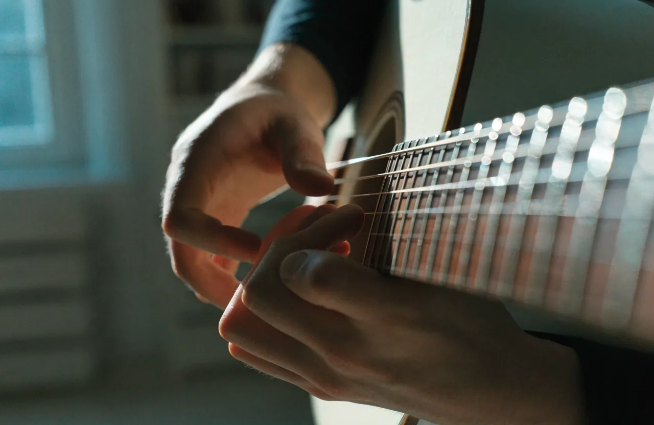 Chord-grid page beside a half-filled tablature stave under cool daylight